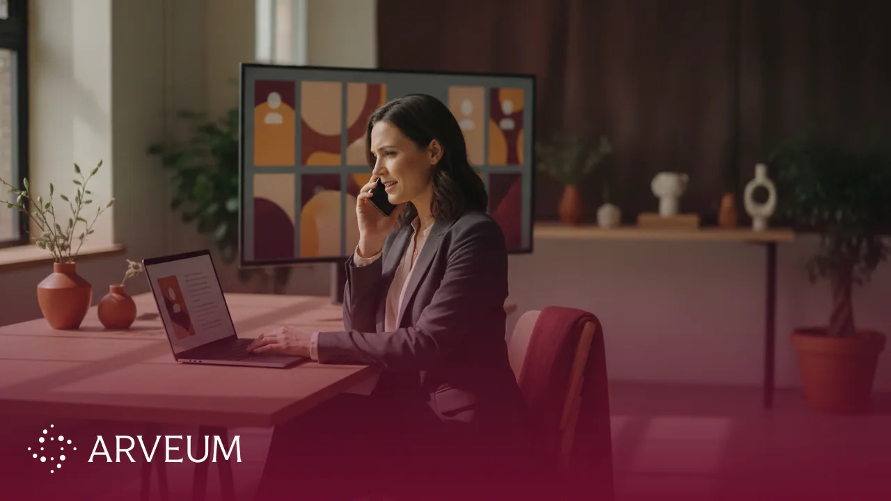 Symbolbild Active Sourcing: ein Recruiter spricht am Schreibtisch gezielt potenzielle Kandidaten über Laptop und Smartphone an.